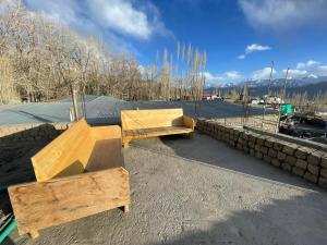 two wooden benches sitting on top of a roof at Rumi Cafe and Stay in Leh