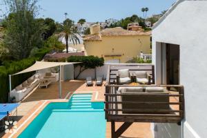 a view of the pool from the balcony of a house at Villa Yelir by Abahana Villas in Calpe