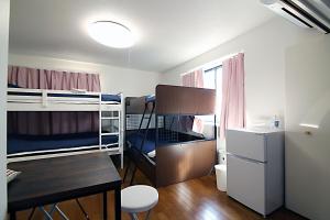 a small room with two bunk beds and a desk at TOKYO MY HOME in Tokyo