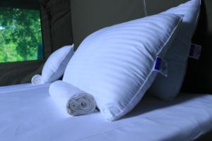 two white pillows on a bed in a room at Leopard Glamping - Luxury Mobile Campsite in Yala & Kumana in Matara