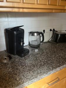 a kitchen counter with a coffee maker and a toaster at FeWo Anastasija 