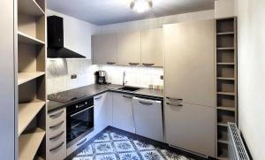 a small kitchen with white cabinets and appliances at Bunkr Karlštejn in Karlštejn