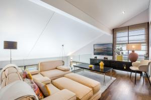 uma sala de estar com um sofá e uma mesa em Exquisite 5-Bedroom Villa in Arzier for Families by GuestLee em Arzier
