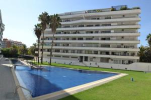 a large building with a swimming pool in front of a building at Cèntric i tranquil a 1,7 kms de Port Aventura in Salou
