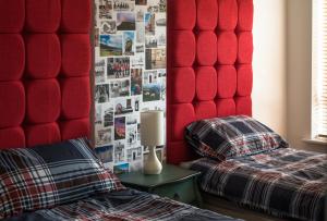 a bedroom with two beds and a red headboard at Cambridge Orchard Apartments - 2 double bedrooms in Cambridge
