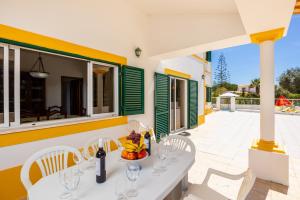 a white table and chairs on a patio at Villa Sol Nascente in Porches