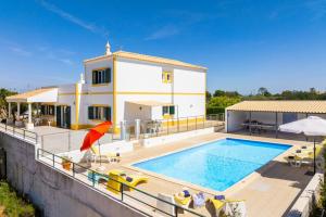 a villa with a swimming pool and a house at Villa Sol Nascente in Porches