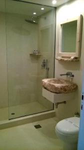 a bathroom with a shower and a sink and a toilet at Scorpios Hotel & Suites in Samos