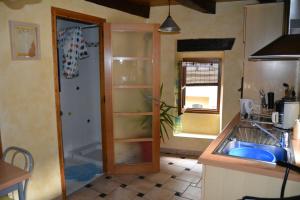 a kitchen with a sink and a counter top at Studio cœur de village in Estaing