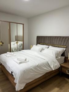 a large white bed with two white towels on it at Luxury Villa Mojito in Široki Brijeg