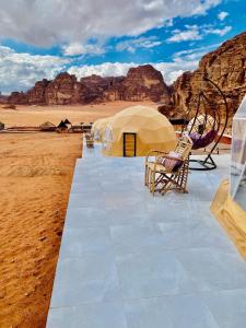a marquee in the desert with chairs and tents at Youssef camp Wadi Rum in Wadi Rum