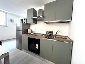 a kitchen with a sink and a refrigerator at Romano home 1 in Bari +9 photos