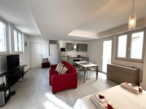 a living room with a red couch and a kitchen at Romano home 1 in Bari