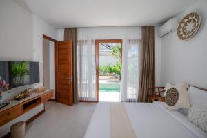 Tempat tidur dalam kamar di Villa Sakura Nusa Dua