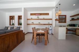 a kitchen and living room with a table and chairs at Villa Sakura Nusa Dua in Nusa Dua