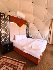 a bedroom with a large bed in a tent at Daniela Camp Wadi Rum in Wadi Rum
