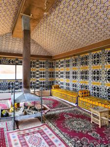 a living room with a fireplace and colorful tiles at Daniela Camp Wadi Rum in Wadi Rum