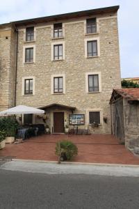 a large brick building with a large patio at Affittacamere Casa di Elide in Fondi