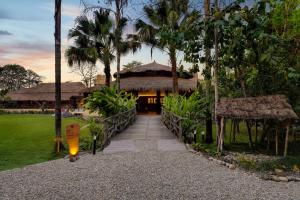a walkway leading to a resort with a building at Tigerland Safari - A Lemon Tree Resort, Chitwan, Nepal in Patlahara