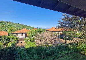 a view of a yard with houses and trees at Zimbali KJ01 4 Bedroom Home in Ballito