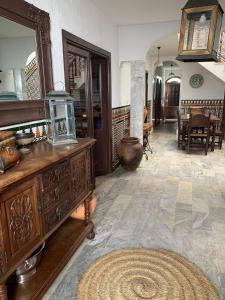 a living room with a large mirror on a wooden dresser at Casa Moya Villa Lujo in Alájar