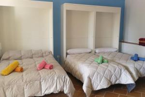 2 camas con almohadas coloridas en una habitación en Villa Marichu. Piscina, BBQ y a 15 min Puy du Fou, en Totanés