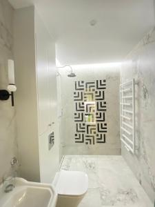 a bathroom with a toilet and a sink at Apartament Środowa 6 by Prestige Home in Szczecin +23 photos