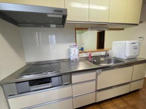a kitchen with a sink and a stove at Kisarazu - House - Vacation STAY 06328v in Kisarazu