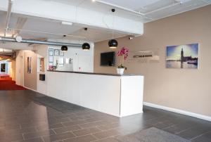 a white counter in a room with a picture on the wall at Stockholm Hostel in Stockholm