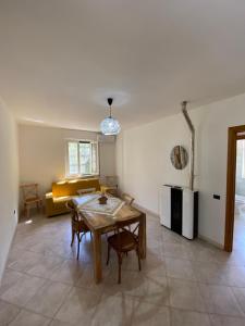 a living room with a table and a couch at Villa Laurus in Torre dell'Orso