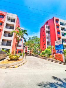 a street in a city with two tall buildings at Aashvi Cozy Cabin Hostel near Mactan Airport in Pusok