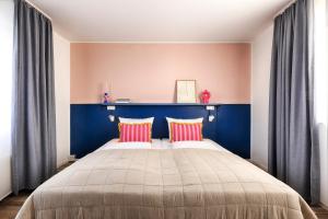 a bedroom with a large bed with a blue headboard at MaxAparthotel by homekeepers in Fürth