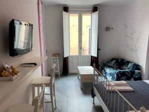 a small room with a bed and a living room at Guest house Le Sibille in Taormina