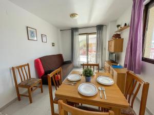 a living room with a table and a couch at Apartamentos Olimpo 3000 in Peniscola