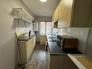 a kitchen with a sink and a counter top at Beautiful 3-Bed Apartment in Hythe High Street in Hythe