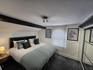 a bedroom with a large bed and a window at Oxton Apartments - JCS Property 10 minutes from Central Liverpool in Upton