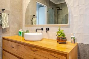 a bathroom with a sink and a mirror at Frankston South Beachside Gem in Frankston South