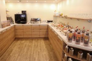 a kitchen with a counter with many bottles on it at Das Frühstückshotel Büsum in Büsum