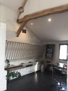 a room with a fireplace and a table in a room at Le Breuil in Amboise