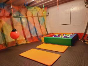 a childrens play room with a play table and a net at Gîte Le Sambre in Thuin