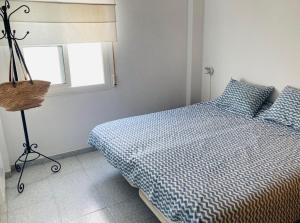a bedroom with a bed and a window at Holiday Home La Atalaya de Conil in Conil de la Frontera