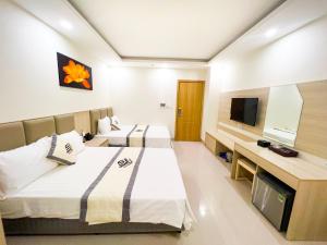 Giường trong phòng chung tại Khách sạn Việt Yên Sầm Sơn