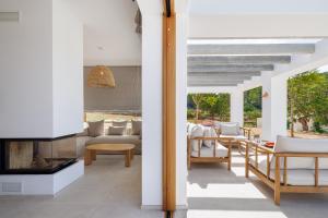 a living room with a couch and a fireplace at Can Lluc Hotel Rural in Sant Rafael de Sa Creu