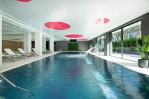 a swimming pool in a hotel with blue water at Gryf Ośrodek Pobierowo in Pobierowo