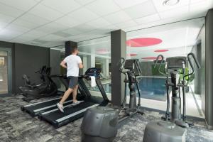 a man walking on a treadmill in a gym at Gryf Ośrodek Pobierowo in Pobierowo