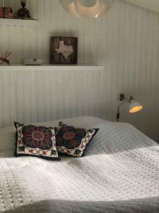 a bedroom with a bed with two pillows at Funen Cottage With Fantastic Sea View, in Assens