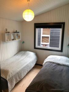 a bedroom with two beds and a window at Funen Cottage With Fantastic Sea View, in Assens