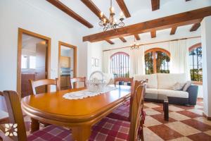 a dining room with a table and a couch at Villa Paula by Abahana Villas in Benissa