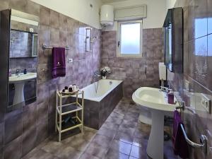 łazienka z wanną i umywalką w obiekcie La tua vacanza in Salento w mieście Porto Badisco