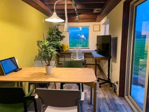 a dining room with a table with chairs and a television at FLEXWORK tawa - Vacation STAY 75198v in Teshikaga